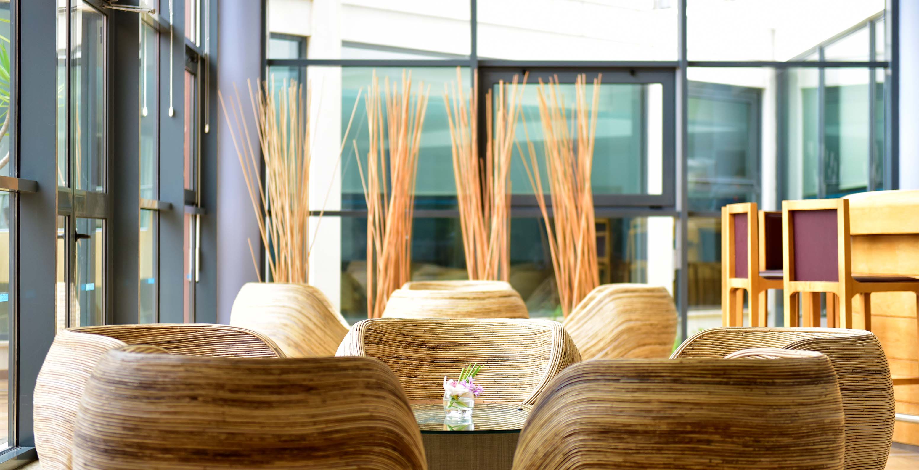 O bar A Adega, do Aparthotel no Algarve, tem cadeiras redondas com mesas centrais e balcão do bar e portas de vidro