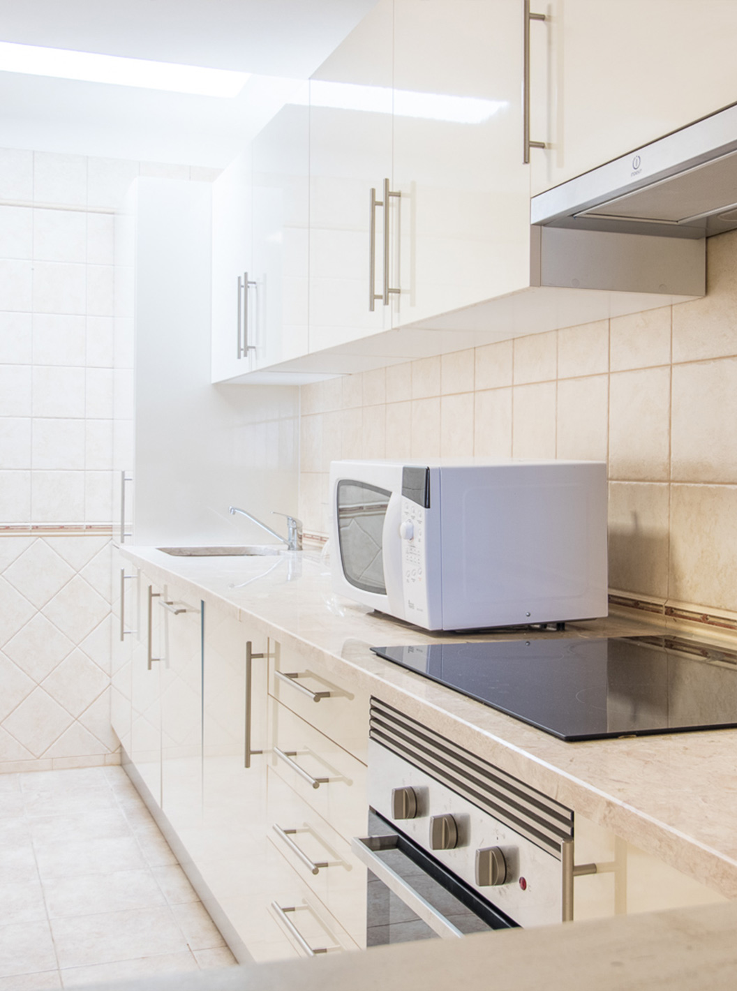 O Apartamento T1 do Pestana Gramacho Residences tem uma cozinha simples com eletrodomésticos e decoração neutra