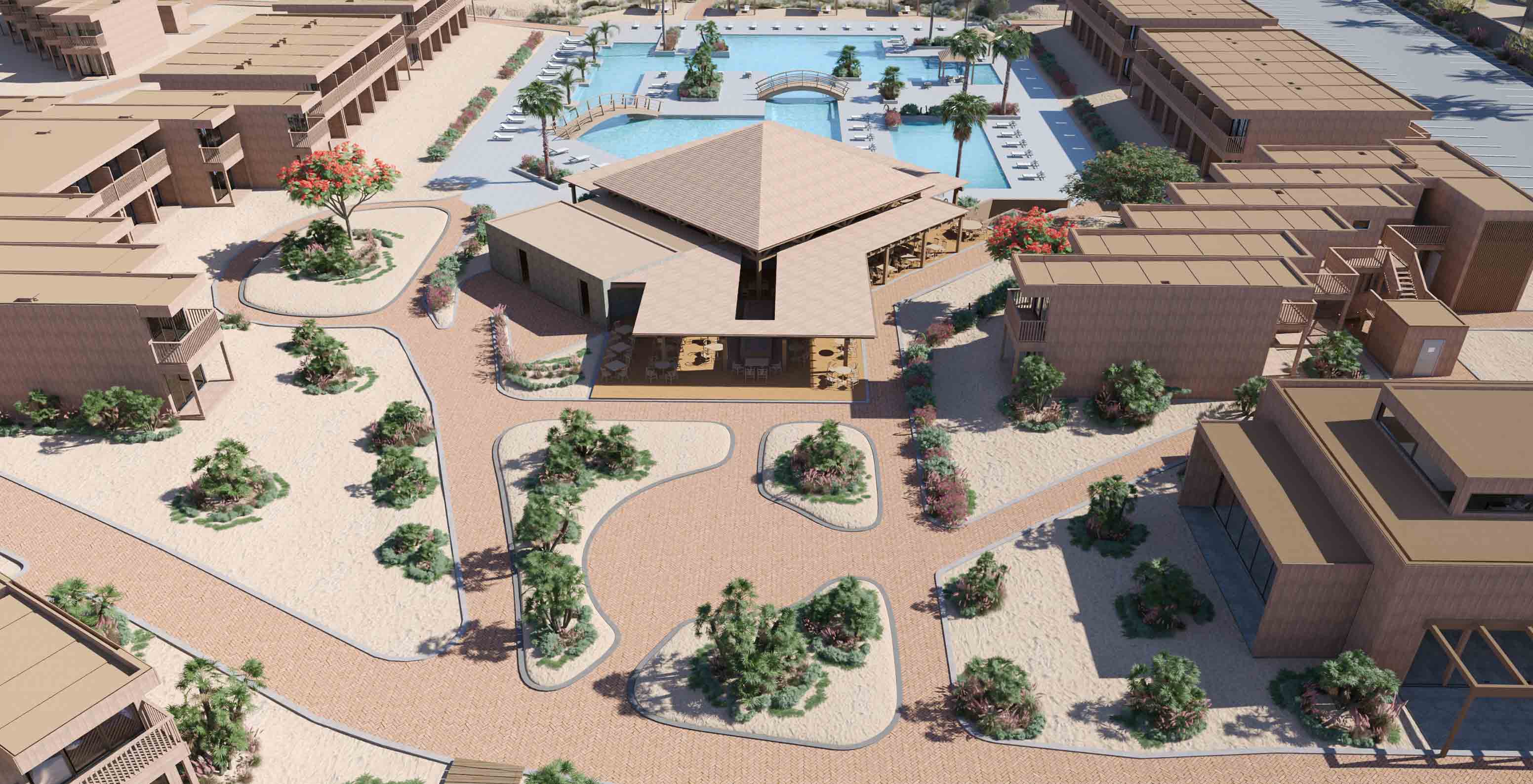 Vista aérea do Pestana Dunas Porto Santo, mostrando edifícios em tons de areia e piscina com pontes e espreguiçadeiras