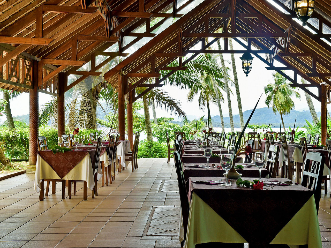 Het restaurant 7 Pedras, van het hotel op Ilhéu das Rolas, in São Tomé, is buiten met een houten dak en uitzicht op zee