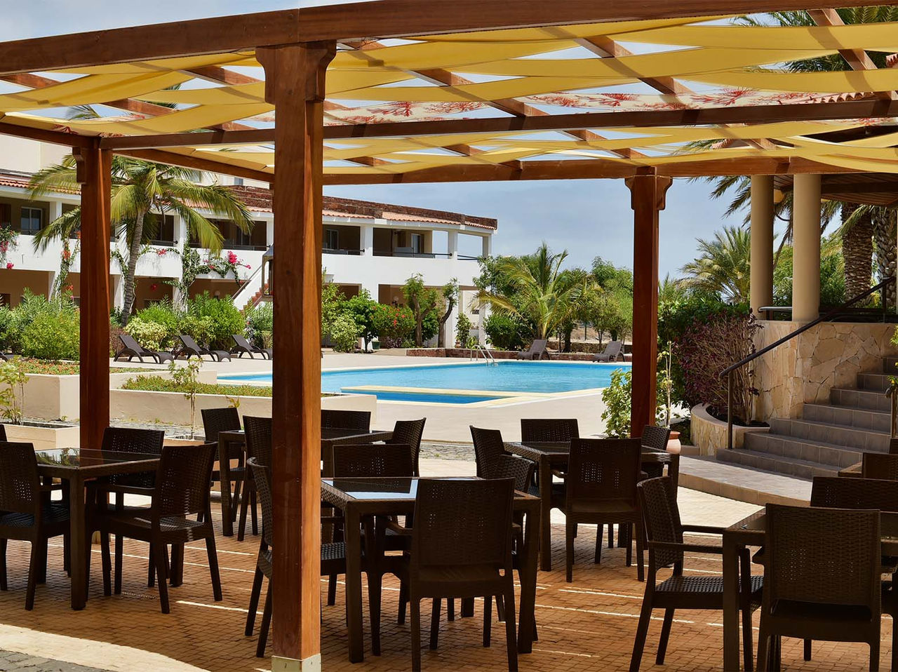 The Ilhéu Bar, at the 4-Star Hotel in Cape Verde, has a covered terrace where guests can dine with views of the pool
