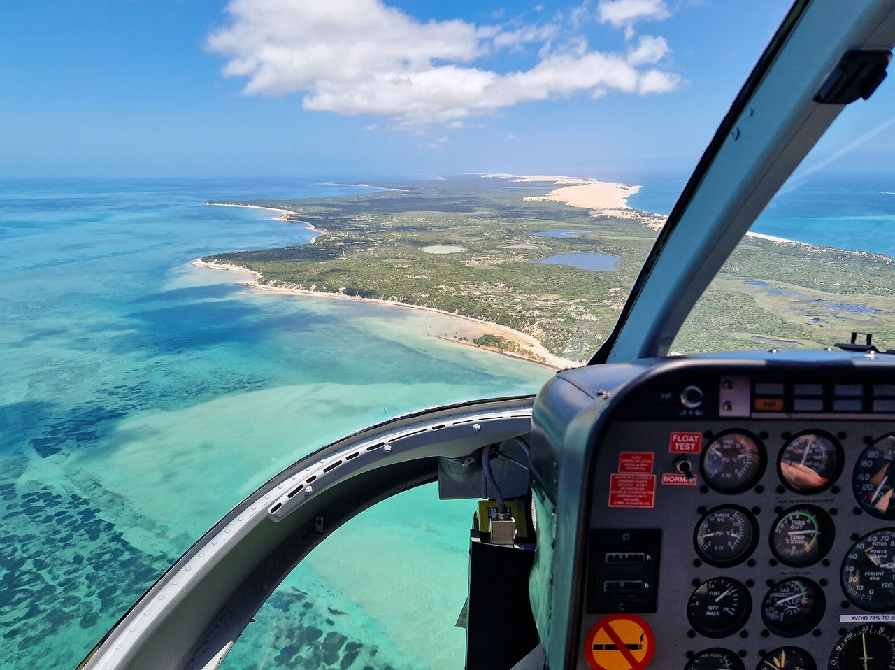 Aerial view from a helicopter of the tropical island of Bazaruto, with a turquoise lagoon and white sandy beaches