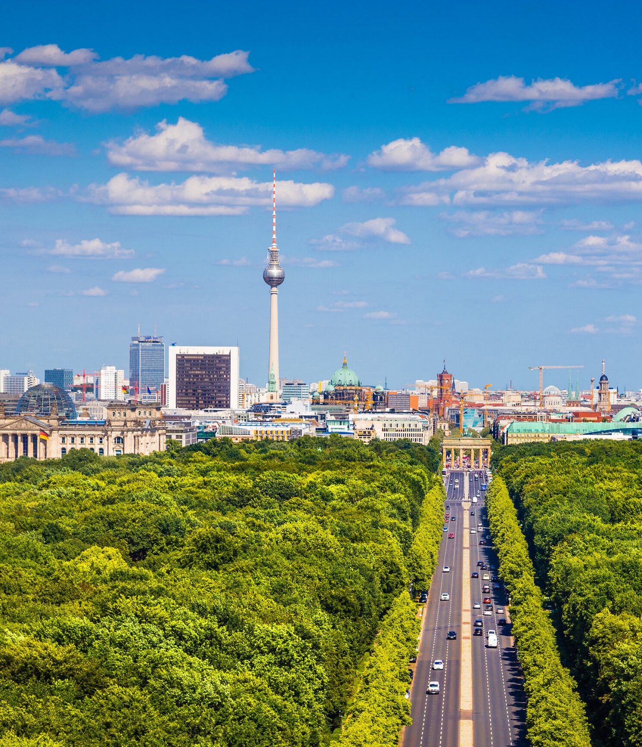 Aerial view of Unter den Linden Avenue in Berlin, surrounded by trees with the Television Tower in the background