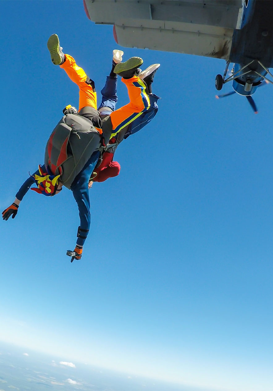 Boy skydiving in the Algarve free falling with arms open and adrenaline rush surrounded by blue sky