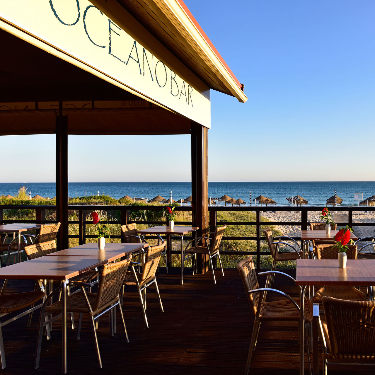 View of the beach at Alvor accessed by Pestana Dom João II, with calm sea and blue sky with few clouds
