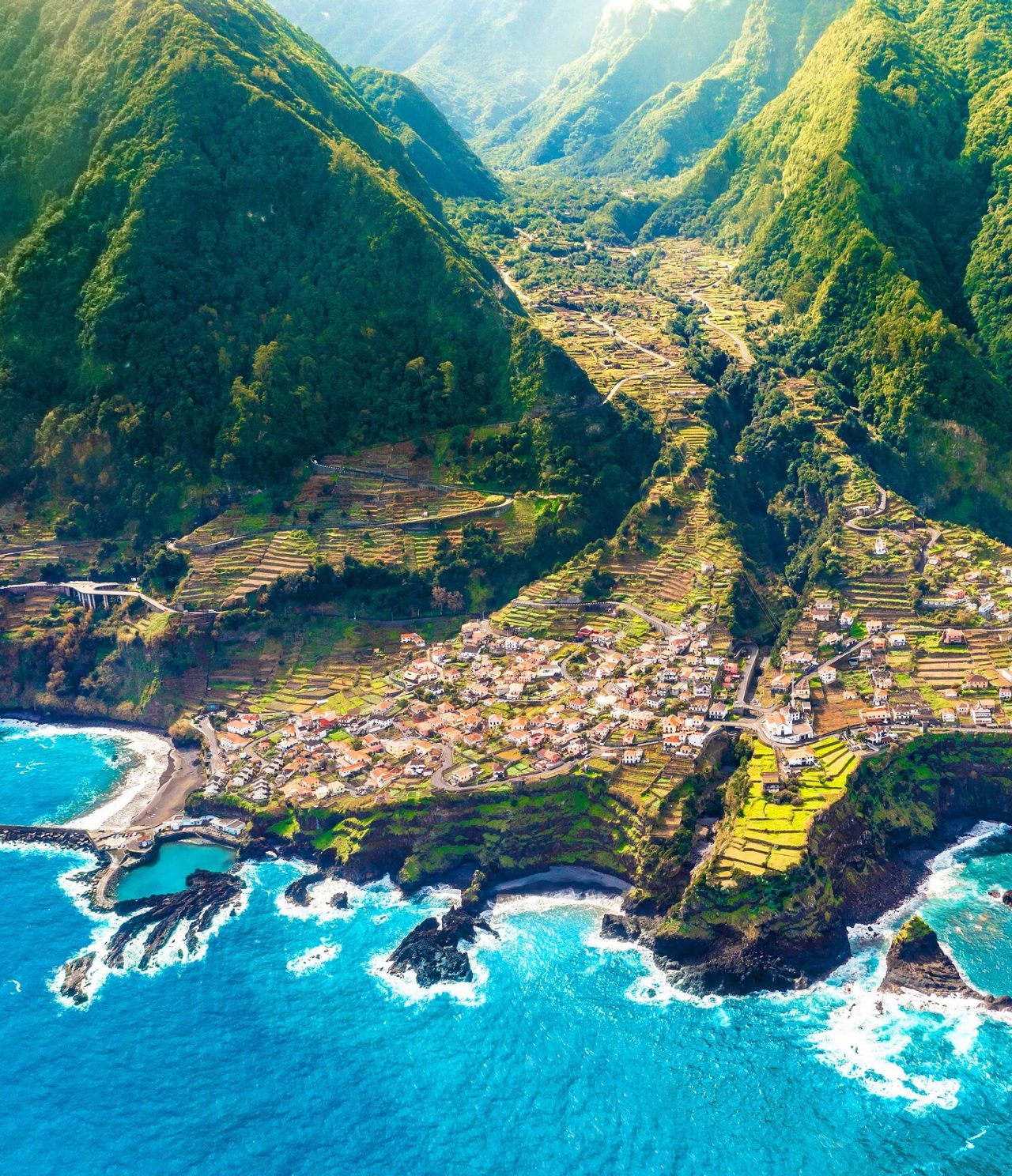  Aerial view of a fajã in a valley, with lush vegetation