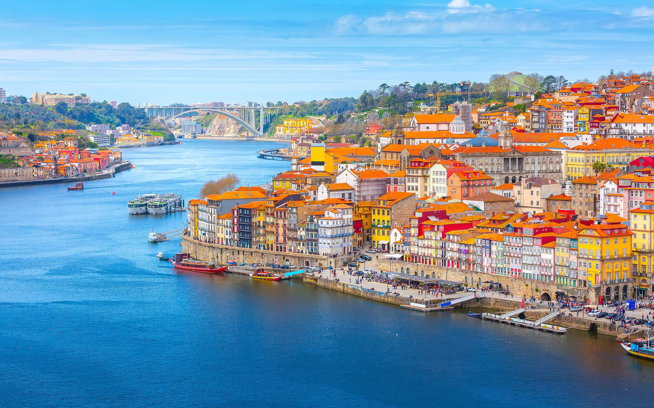 People enjoying the view of Ribeiro do Porto, a historic and tourist spot over the Douro River and the Dom Luís I Bridge
