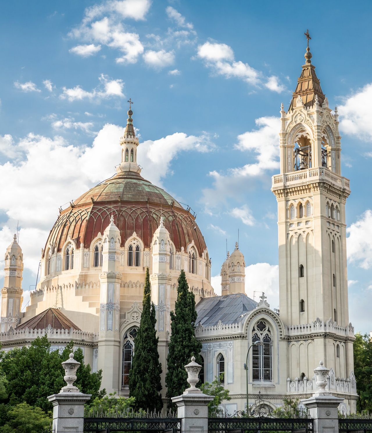 View of the Almudena Cathedral with its imposing dome and a tower beside it
