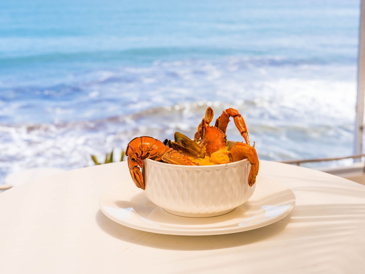 Seafood dish highlighting shrimp and crab, with panoramic ocean view in Miami