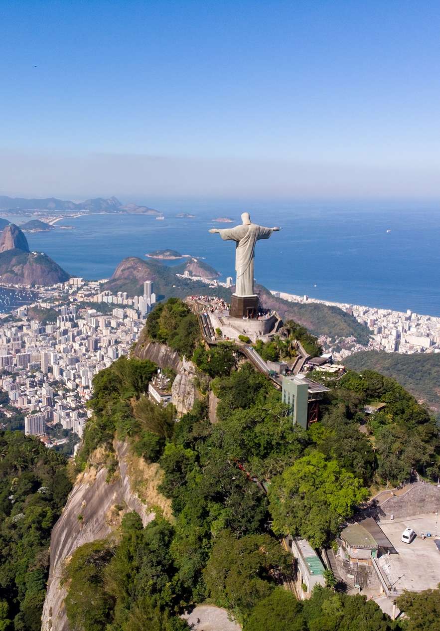 Statue of Christ the Redeemer in Corcovado one of the most iconic mountains in Rio de Janeiro with the sea in the background